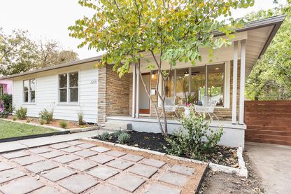 White bungalow with tree in front yard, Cherrywood, East Austin